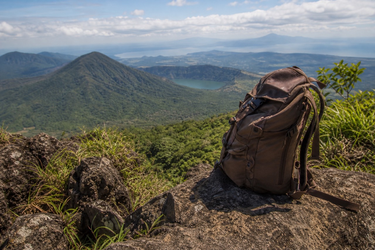 Solo hiker with a daypack joining a group of walkers on the forest trail up Santa Ana Volcano