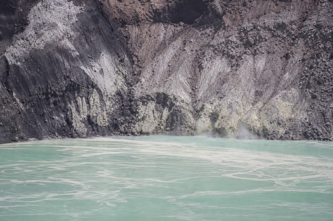 Close view of the milky turquoise sulfuric lake inside the Santa Ana Volcano crater in El Salvador